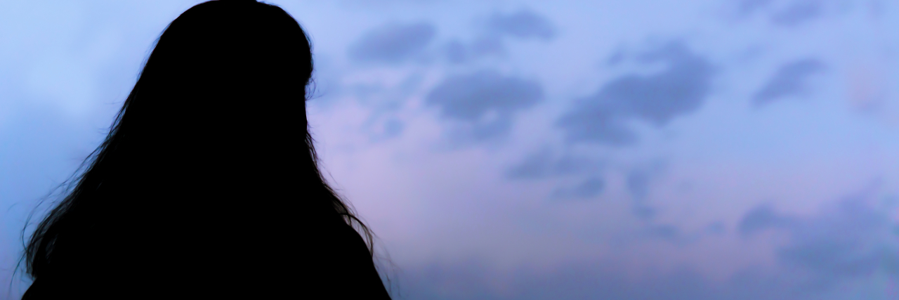 Growing Up With Hydrocephalus silhouette of woman looking at a blue sky