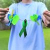Green ribbon, hearts, pinned to clothesline.