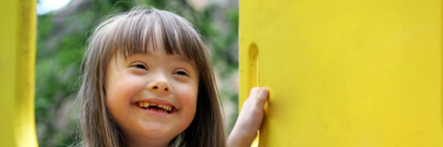 Girl with Down syndrome on a playground.