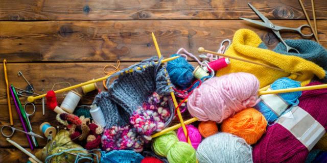 Enjoying hobbies with a chronic illness: Knitting needles and yarn.