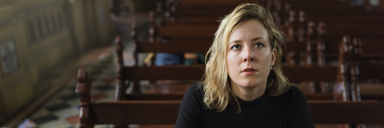 When the Church Dismissed My Suicidal Thoughts and Abuse Woman sitting in a pew at church looking up