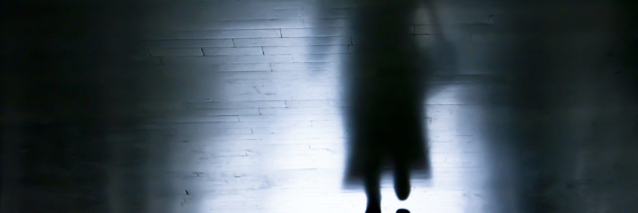 When Weighing Yourself Triggers Your Eating Disorder Shadow of a woman walking in dark alley