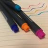 Colorful pens and notebook.