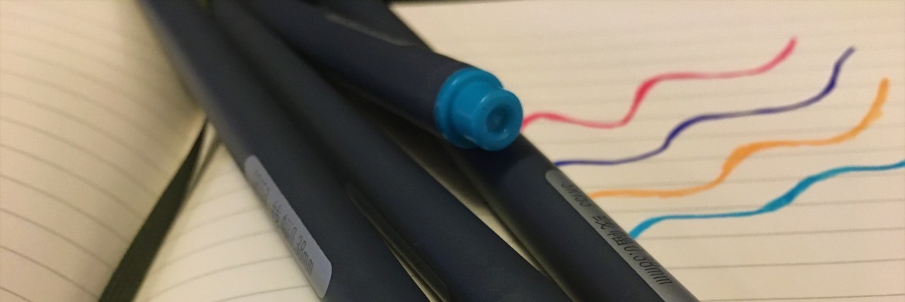 Colorful pens and notebook.