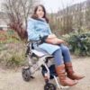 Simone outdoors in her wheelchair.