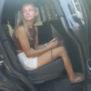 photo of Gabby Petito sitting in a car talking to police from bodycam footage