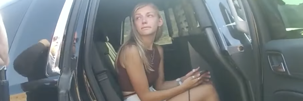 Gabby Petito: Police Missed These Signs of Domestic Abuse photo of Gabby Petito sitting in a car talking to police from bodycam footage