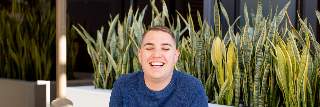 Kyle sitting at a table outside.