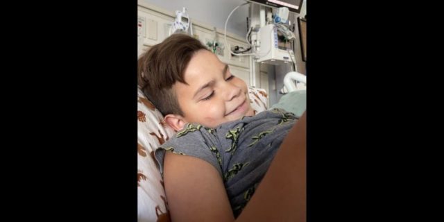 When Do You Know It's Time to Pull Your Child From School? a boy smiling in his hospital bed