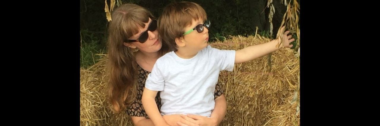 The Change in Social Circles While Parenting a Child With a Disability a mother sitting with her son with a disability on her lap