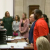 photo of R. Kelly in orange jumpsuit in courtroom during trial for sexual abuse