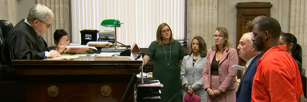 R. Kelly’s Conviction Is a Victory For All Sexual Abuse Survivors photo of R. Kelly in orange jumpsuit in courtroom during trial for sexual abuse