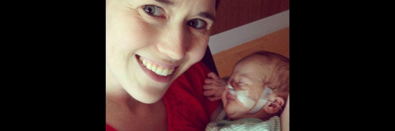 Embracing Your Child's Birth Defect a mother cradling her newborn baby with a nose canula