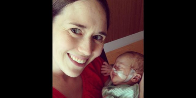 How to Embrace Your Child's Birth Defect a mother cradling her newborn baby with a nose canula