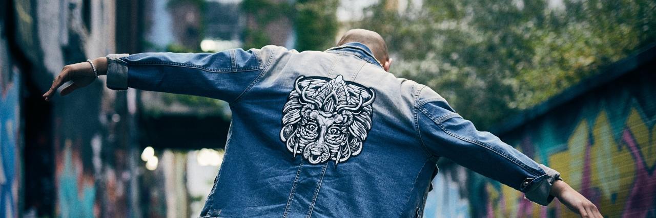 How ‘Radical Acceptance’ Builds a Bridge Between the Gulfs of Who I Am photo of a man walking down an alley with his arms outstretched and head lowered