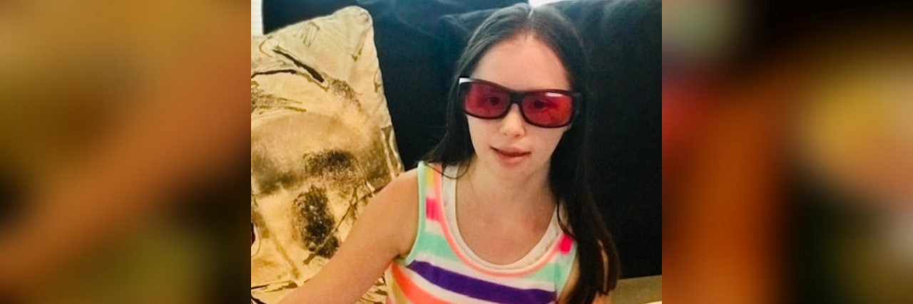 When My Daughter With Down Syndrome Sustained a Traumatic Brain Injury Yassy Harrison a few weeks after her bike accident wearing her Therapsecs glasses