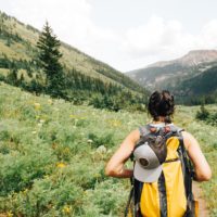 Woman backpacking on a path into the mountains