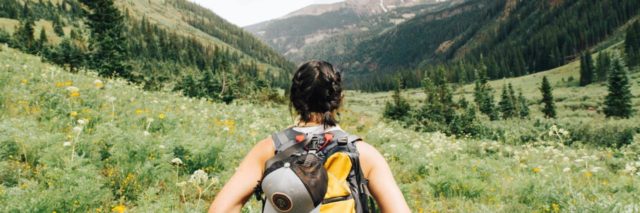 Woman backpacking on a path into the mountains