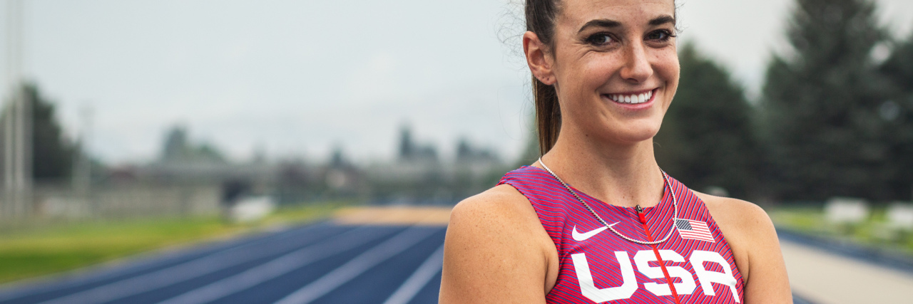 Single-Handedly Reaching for the Gold as a Paralympian in Tokyo Dani Aravich wearing her Team USA uniform at a running track.