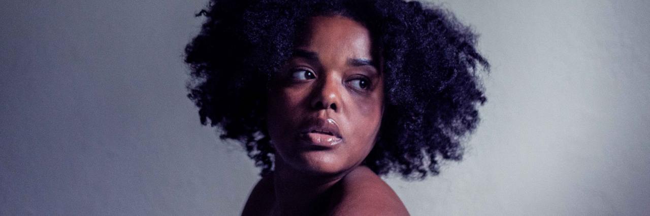 Texas Abortion Law: I Would Have Been Forced to Have My Father's Baby photo of a woman looking back over her shoulder with bare shoulders and a concerned expression