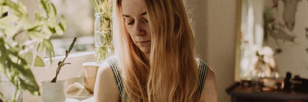 When You Think Family Is Emotionally Abusive About Your Health photo of a woman sitting on the floor by a window