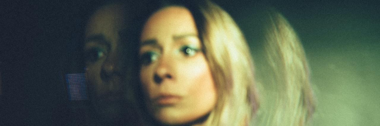 blurred image of a woman looking worried