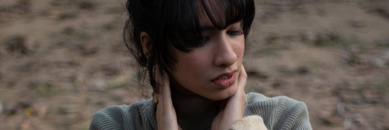 Rejection Sensitive Dysphoria Triggers You Need to Prepare For photo of an indian person with hands raised to their neck looking away upset