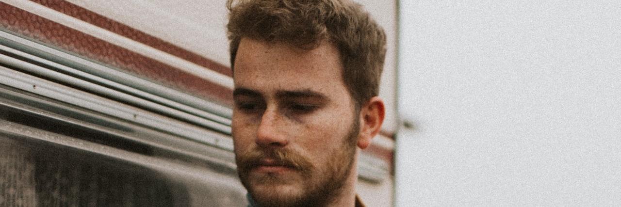 My Process for Accepting That I Have Mental Illness Photo of man outside leaning against vintage RV