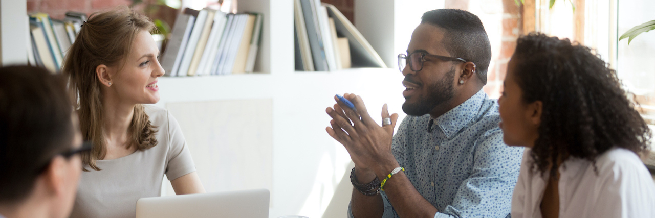 How to Protect Your Mental Health Against a Toxic Boss Group of diverse people sitting around table at the office