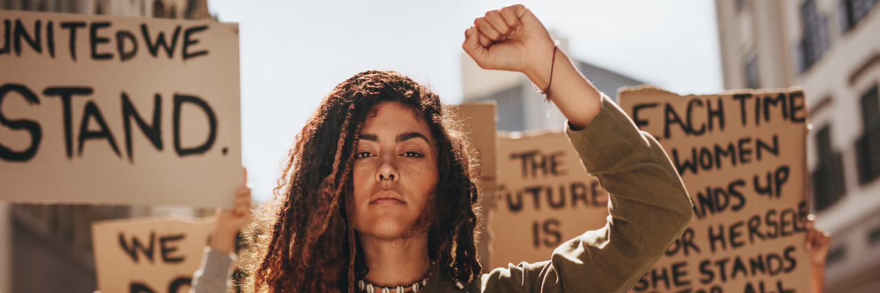 We Must Include Disabled People in the Fight for Reproductive Rights Woman leading a group of people marching for reproductive rights.