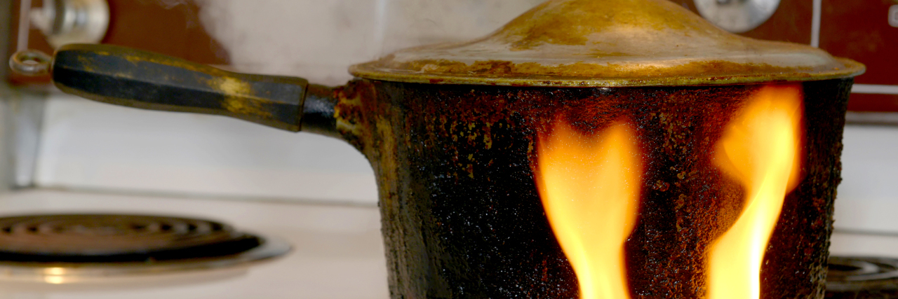 How Acute Pain Added to My Chronic Pain Almost Broke Me An old, covered, charred, blackened pot on a stove.