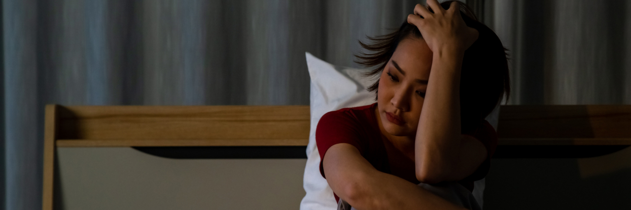 When You Feel Sad for No Reason Depressed or sad asian woman sitting alone on bed at night