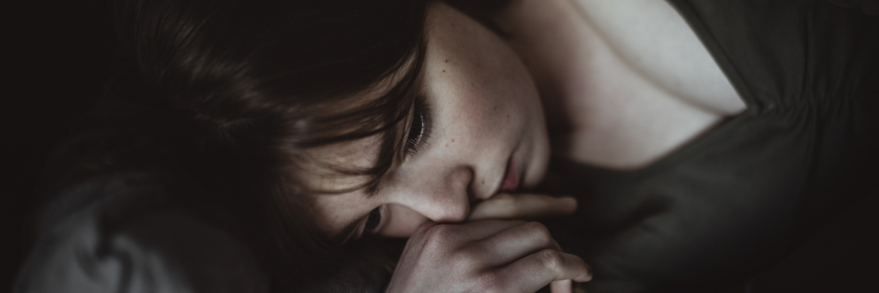 7 Gentle Things to Try When You Just Can't With Depression Close-up of sad woman lying on bed