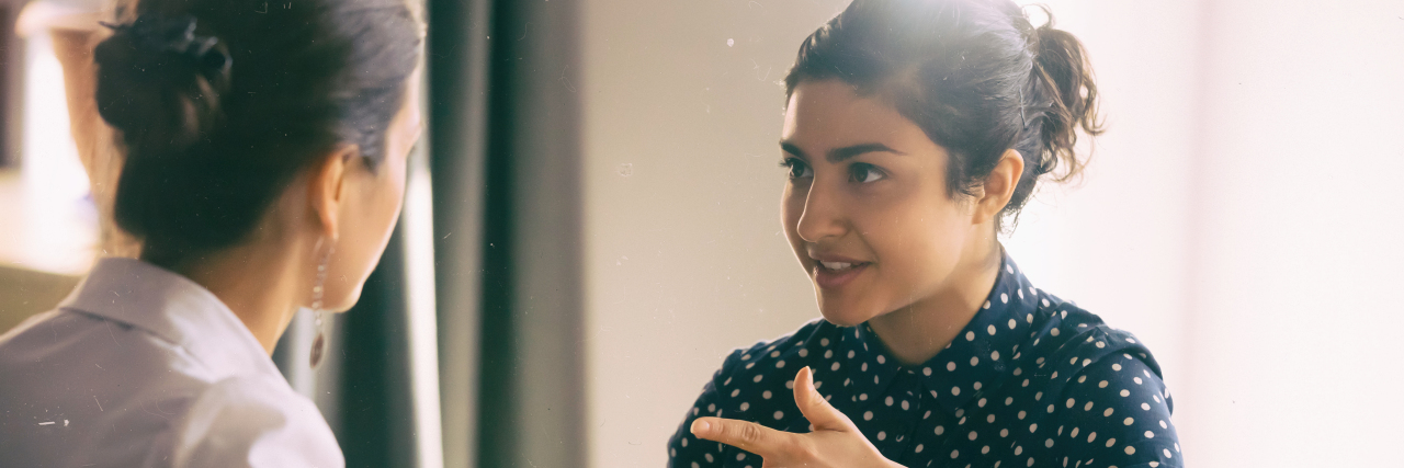 4 Steps to Having Open Conversations About Your Chronic Illness Two women having a serious conversation.