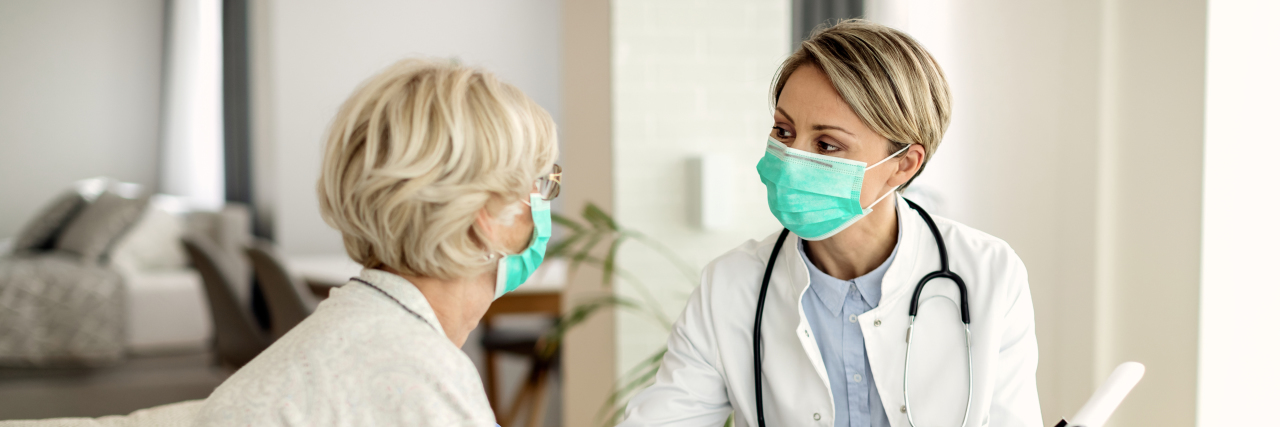 Female doctor talking to older female patient.