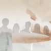 Double exposure panoramic teamwork business join hand together with silhouette business people and modern city background.
