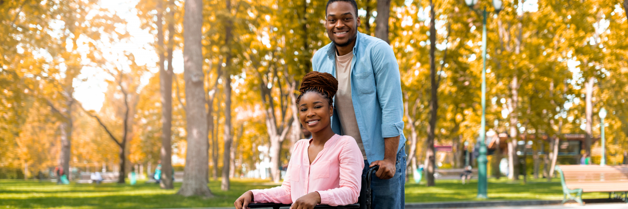 How Using a Wheelchair Makes Date Nights With Chronic Illness Better Husband pushing his wife's wheelchair.