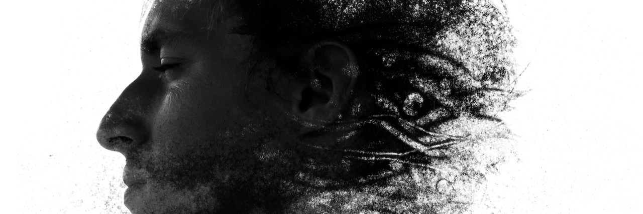 Paintography portrait of man's profile fading into sand particles