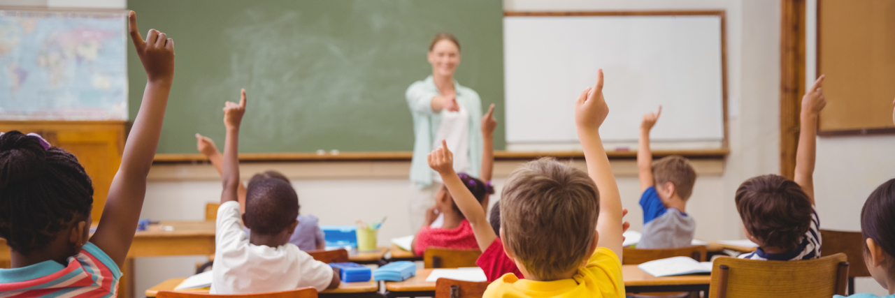 Why Saying 'Change Takes Time' Harms Students With Disabilities Students raising their hands during class at the elementary school.
