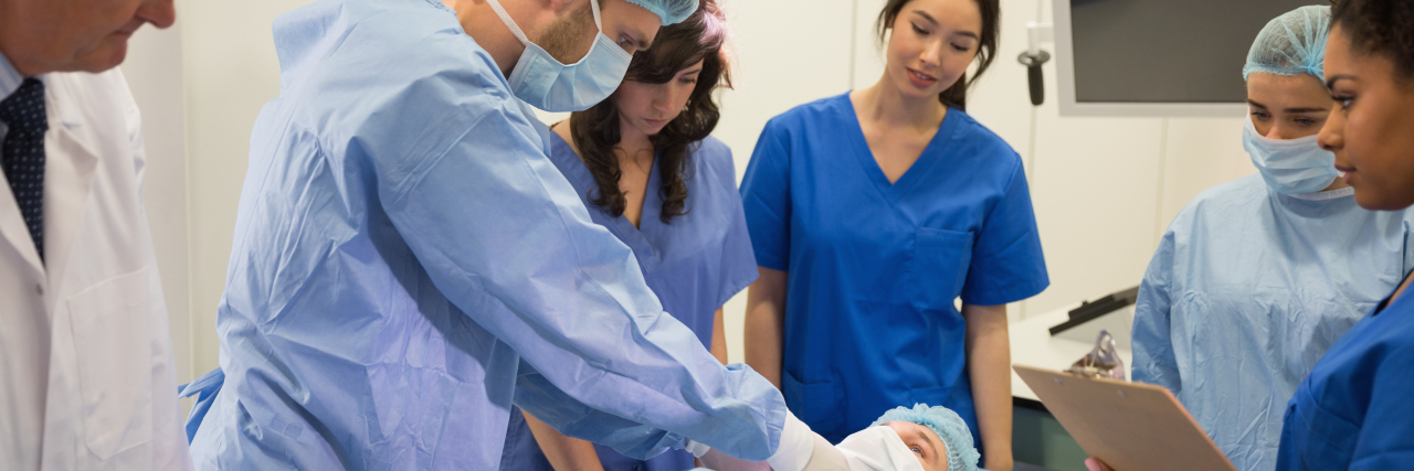 Dear Medical Students: I'm a Disabled Person, Not a Lab Specimen Medical students learning from professor at clinic.