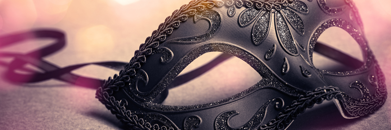 The Masks I Wear Every Day as an Autistic Person Mask over gold background.