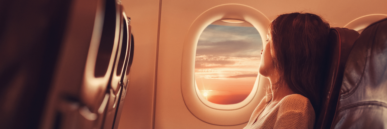 How COVID-19 Impacted My Anxiety and Phobia Coping Skills Young woman sitting in an airplane looking out the window
