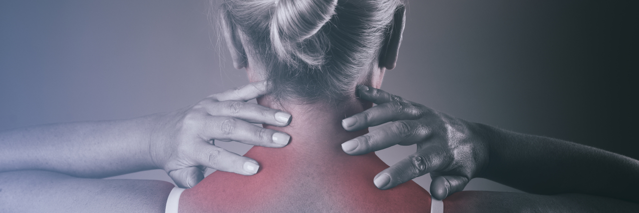 Managing Lifelong Chronic Pain After a 'Minor' Car Accident Woman holding her neck due to chronic pain.
