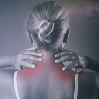 Woman holding her neck due to chronic pain.