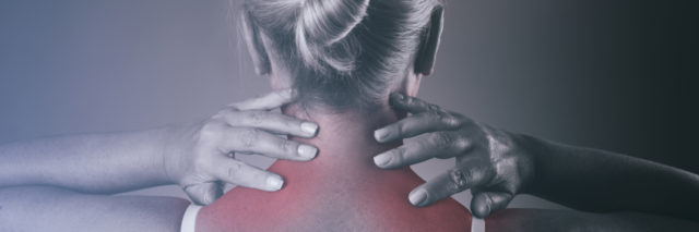 Woman holding her neck due to chronic pain.