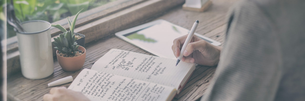Starting Over When You Can No Longer Work Due to Disabilities Woman writing in journal.