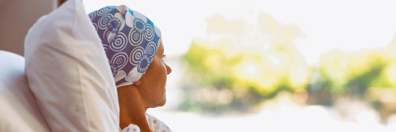 Young woman with cancer in hospital bed.