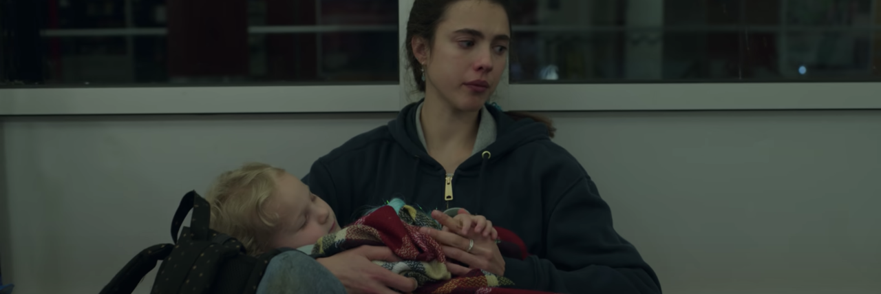screenshot from Netflix series Maid, showing the main character crying and holding her young child