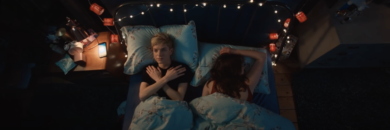 screenshot of Mae and partner lying in bed in Netflix show 'Feel Good'