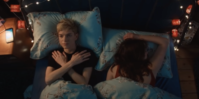 screenshot of Mae and partner lying in bed in Netflix show 'Feel Good'